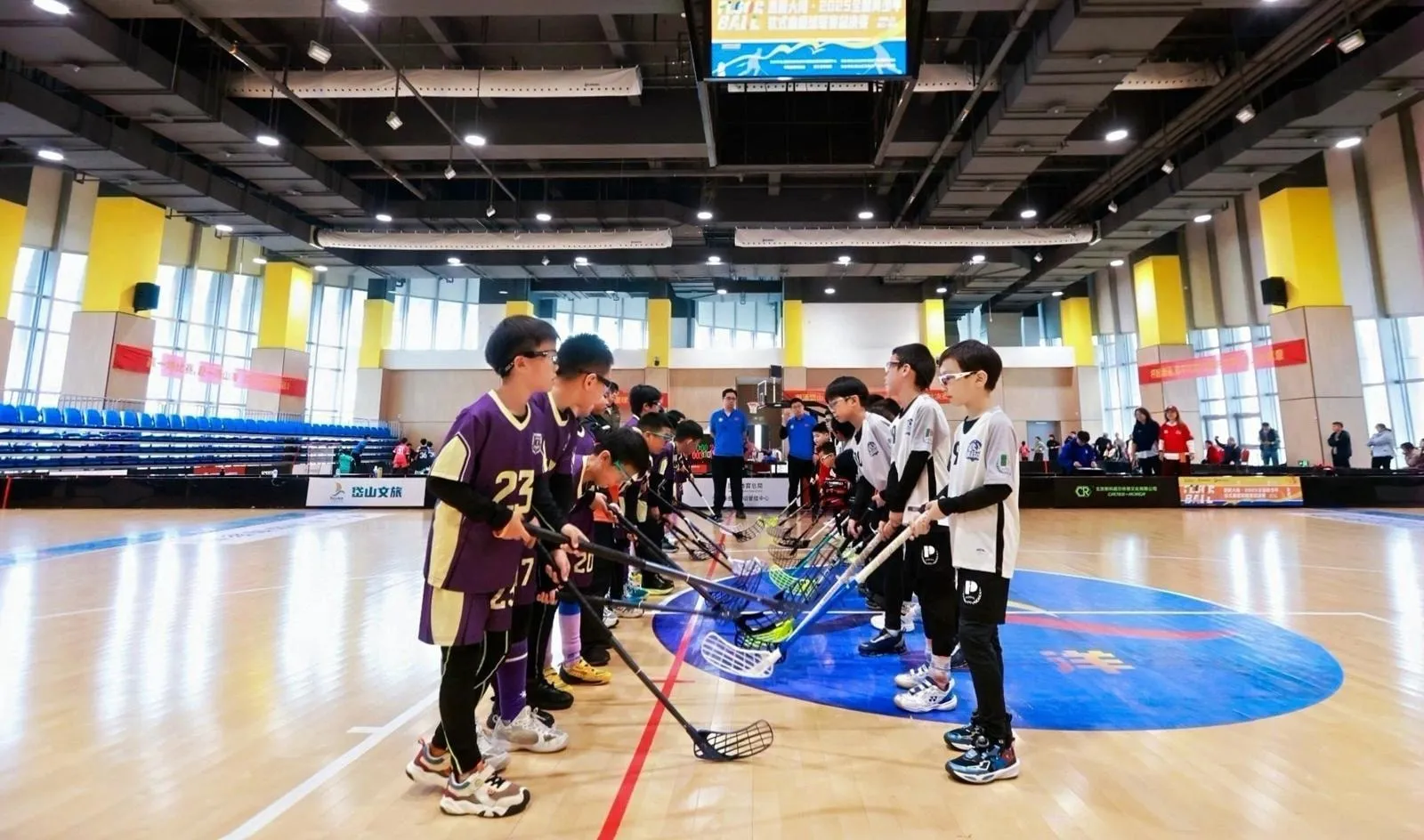 A floorball game in progress in a large indoor hall